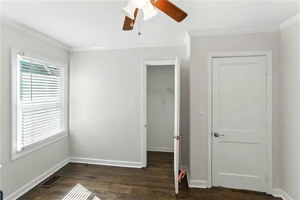 a view of empty room with wooden floor and window