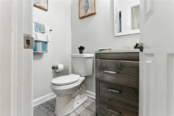 a bathroom with a toilet sink and mirror