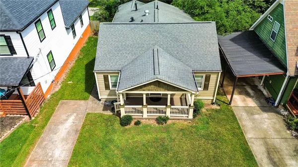 a aerial view of a house next to a yard