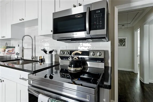 a kitchen with a stove and a microwave
