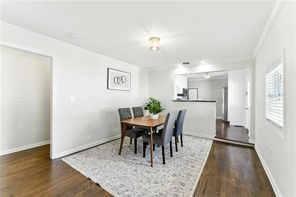 a view of a dining room with furniture and wooden floor