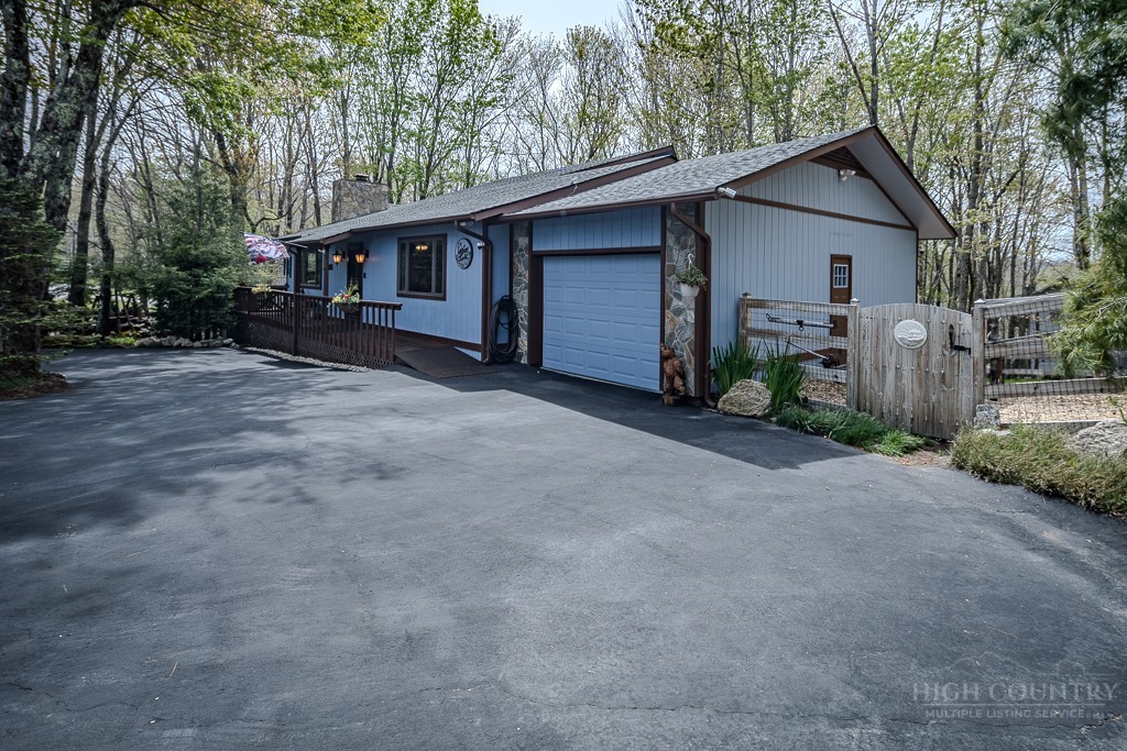 103-105 Upper Grouse Ridge Road Beech Mountain, NC 28604 - Photo 34 of 48 a view of a house with a yard and large tree