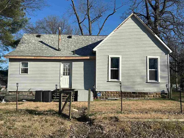 a view of a house with a yard and furniture