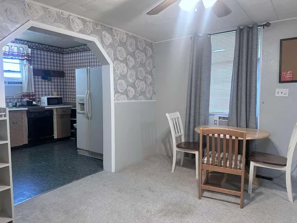 a view of a room with furniture and windows