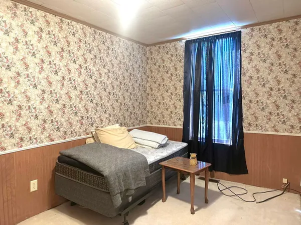 a bedroom with a bed and a window