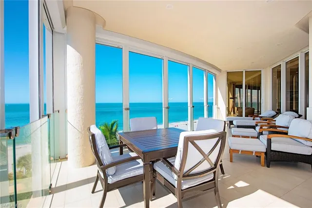 a view of a swimming pool with a table and chairs