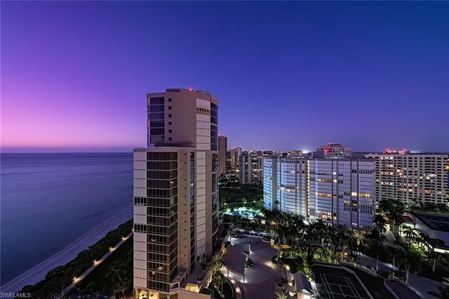 a living room with furniture a mirror and a large window