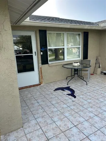 a outdoor space with lots of furniture and a window