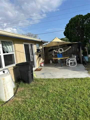 a view of a backyard with patio