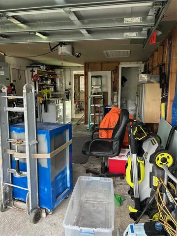 a storage room with stainless steel appliances kitchen island granite countertop a sink and cabinets