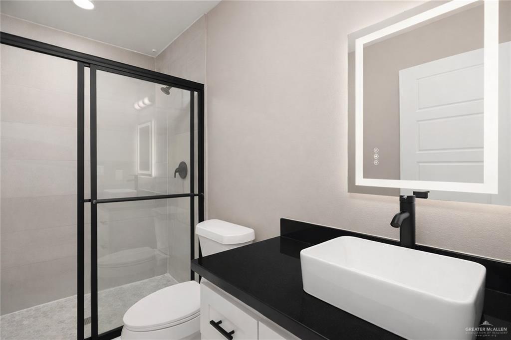 1712 West B Street Mission, TX 78572 - Photo 9 of 11 a bathroom with a sink toilet and shower