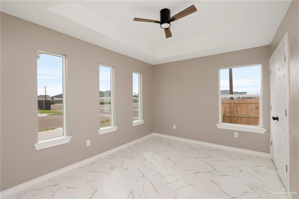 1712 West B Street Mission, TX 78572 - Photo 10 of 11 a view of empty room with windows