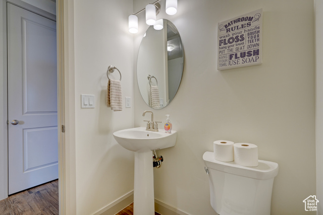1329 Paseos Street Washington, UT 84780 - Photo 21 of 35 Half bathroom with toilet and wood finished floors