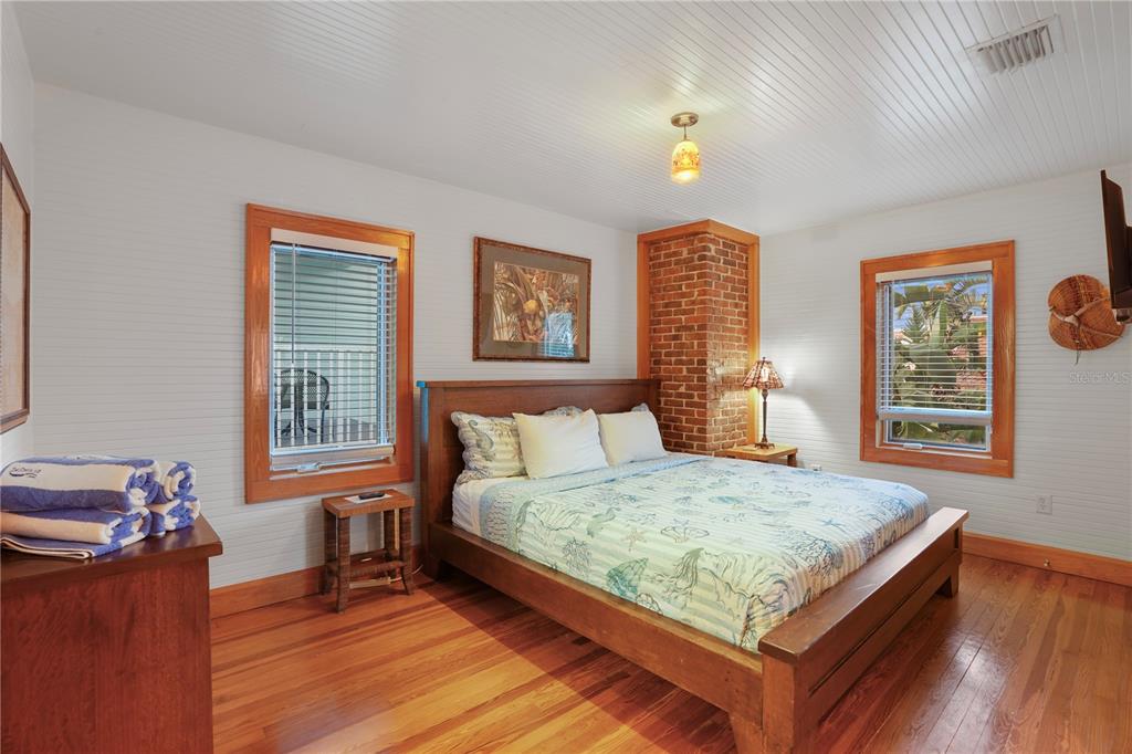 702 Pass A Grille Way St. Pete Beach, FL 33706 - Photo 19 of 41 a bed sitting in a bedroom next to a window