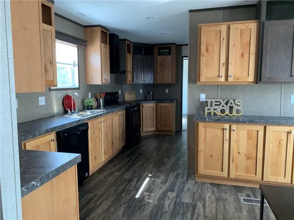 a kitchen with wooden floors and sink