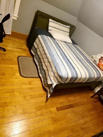 a bedroom with a bed and pillows