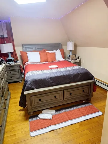 a bedroom with a bed and a mirror