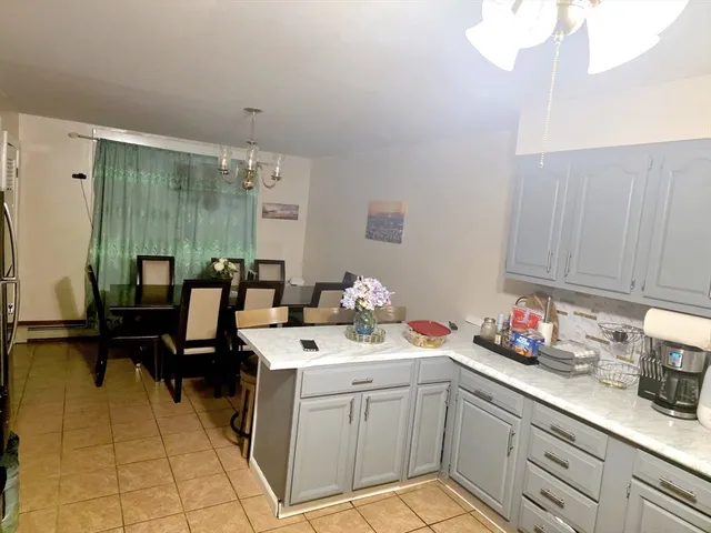a kitchen with a sink dishwasher and cabinets with wooden floor