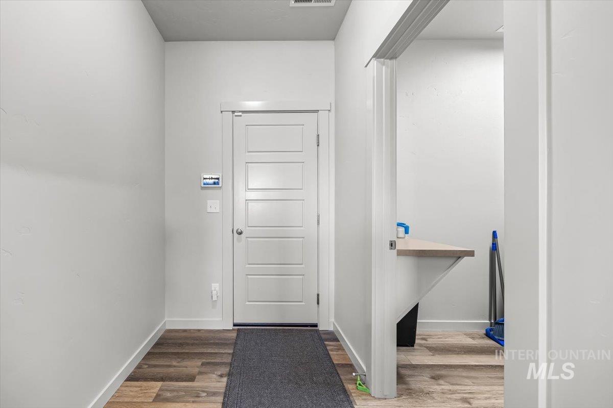 15365 Lutsen Avenue Caldwell, ID 83607 - Photo 15 of 42 Doorway with wood finished floors and baseboards
