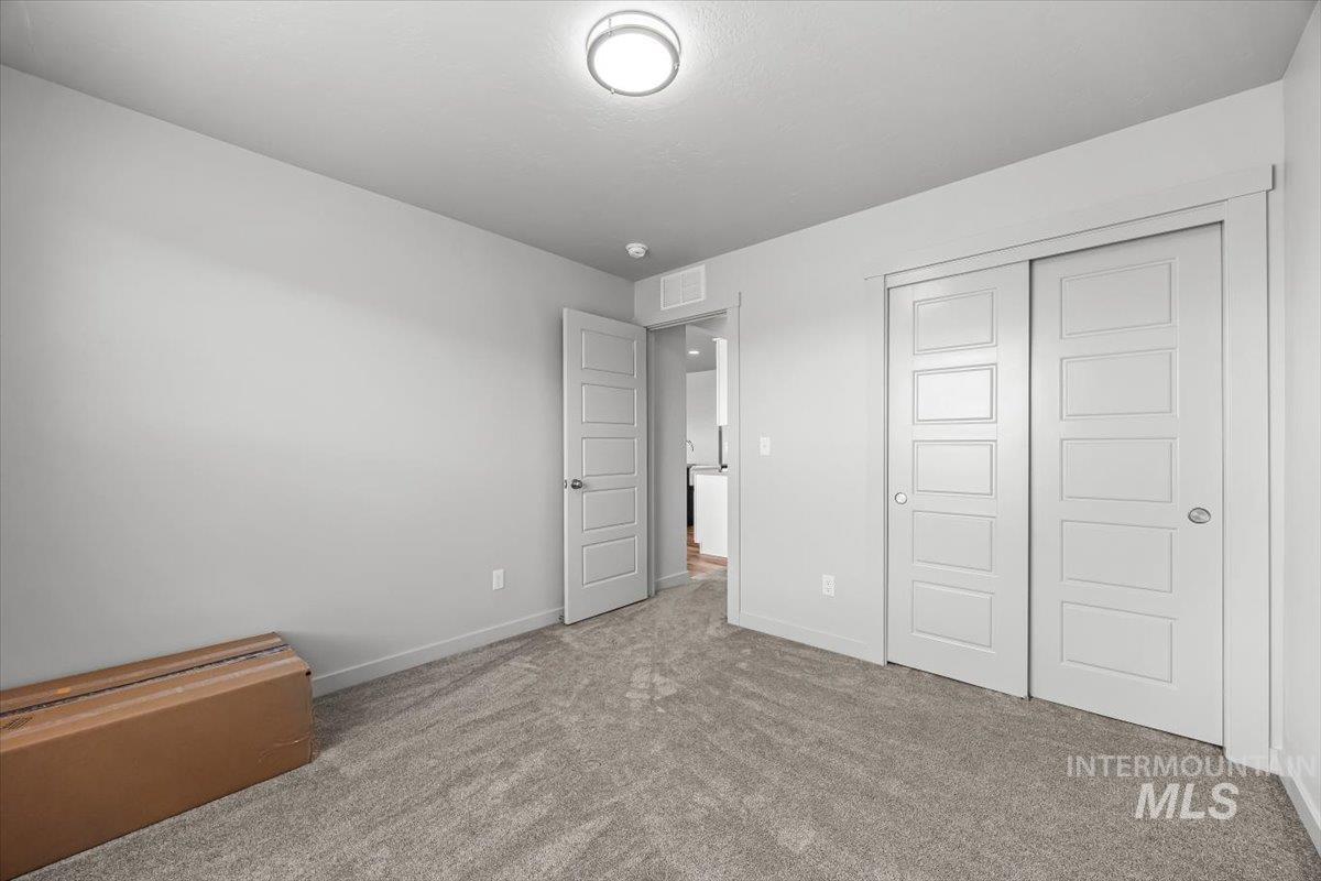 15365 Lutsen Avenue Caldwell, ID 83607 - Photo 23 of 42 Unfurnished bedroom featuring carpet flooring and a closet