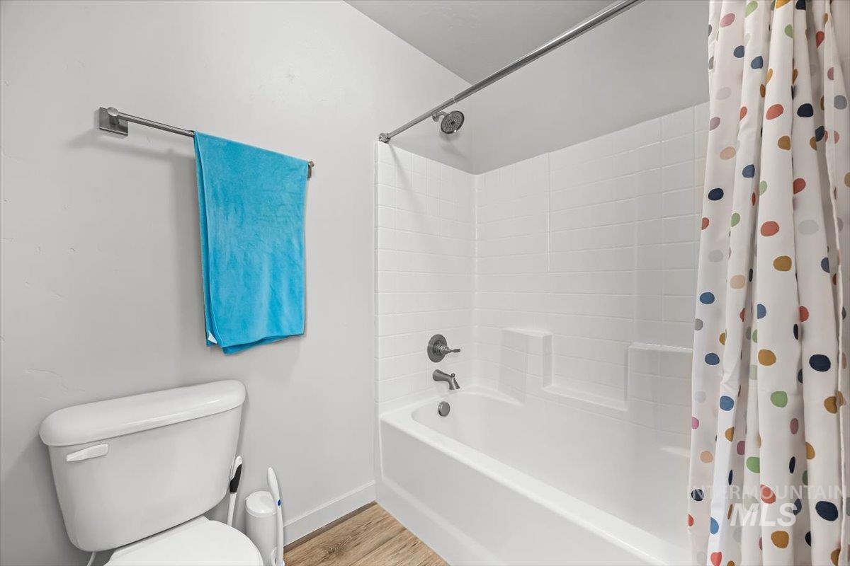 15365 Lutsen Avenue Caldwell, ID 83607 - Photo 25 of 42 Full bathroom featuring shower / tub combo with curtain and wood finished floors