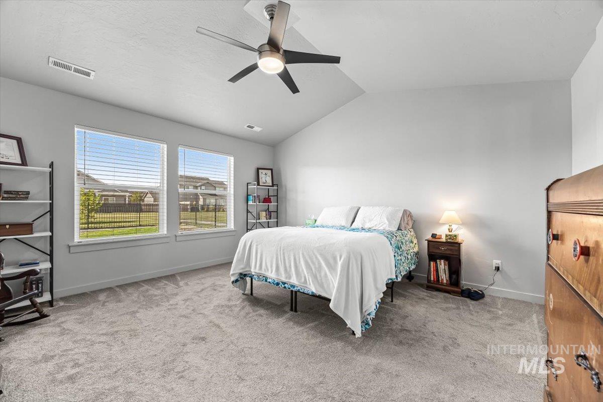 15365 Lutsen Avenue Caldwell, ID 83607 - Photo 27 of 42 Bedroom featuring lofted ceiling, light carpet, and a ceiling fan