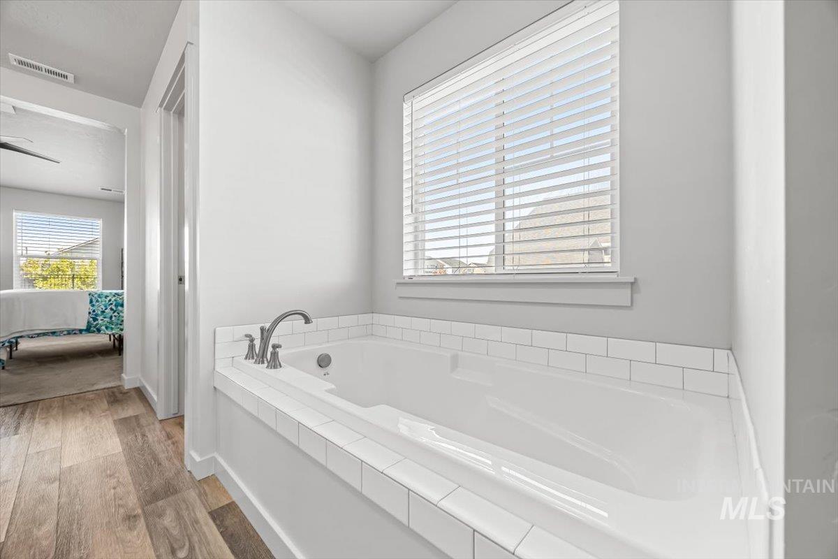 15365 Lutsen Avenue Caldwell, ID 83607 - Photo 31 of 42 Ensuite bathroom with a garden tub and wood finished floors