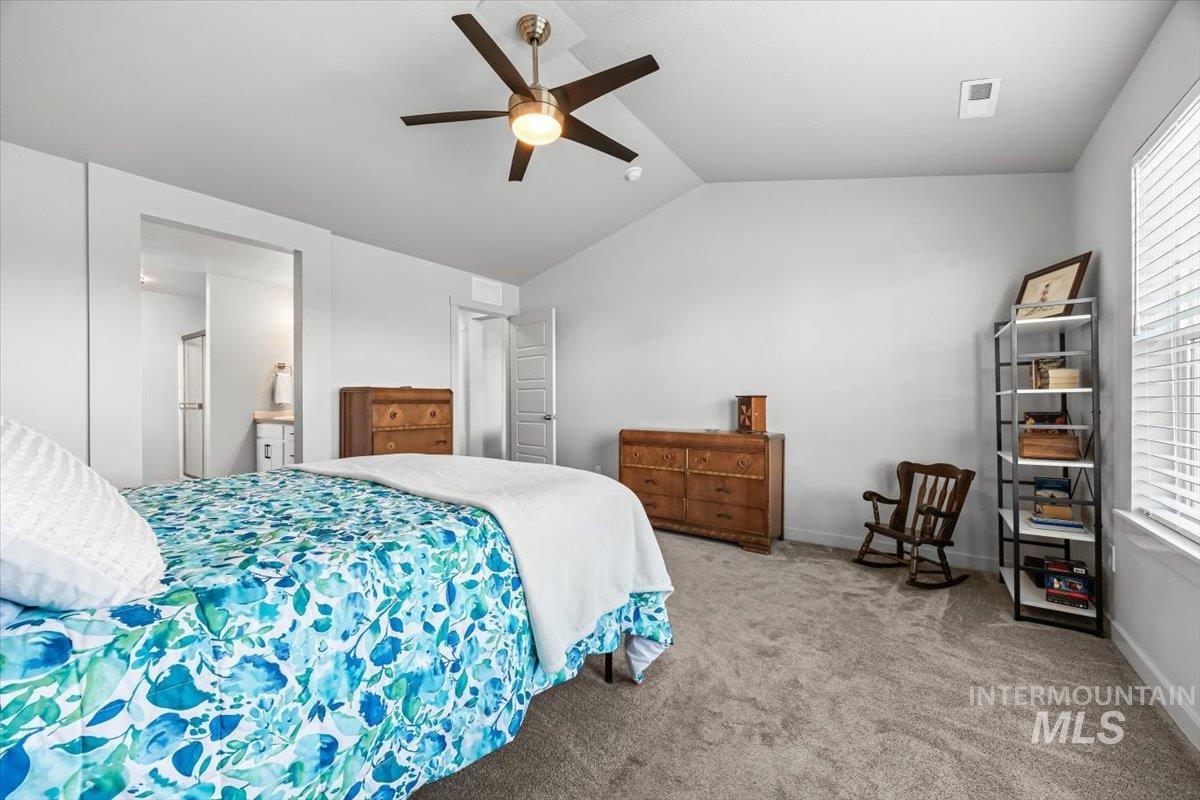 15365 Lutsen Avenue Caldwell, ID 83607 - Photo 32 of 42 Bedroom featuring lofted ceiling, carpet, ensuite bathroom, and ceiling fan