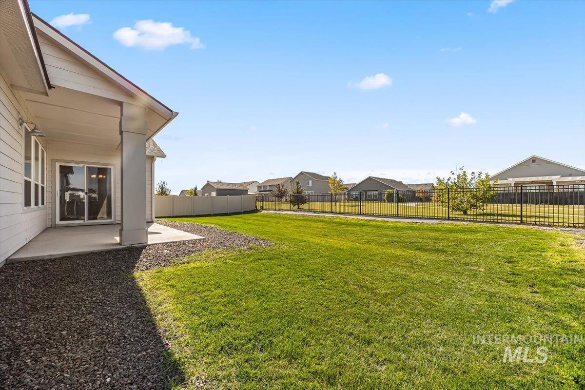 15365 Lutsen Avenue Caldwell, ID 83607 - Photo 33 of 42 Fenced backyard with a patio area and a residential view