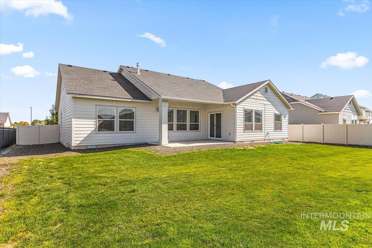 15365 Lutsen Avenue Caldwell, ID 83607 - Photo 34 of 42 Rear view of property with a fenced backyard, a patio area, and a shingled roof