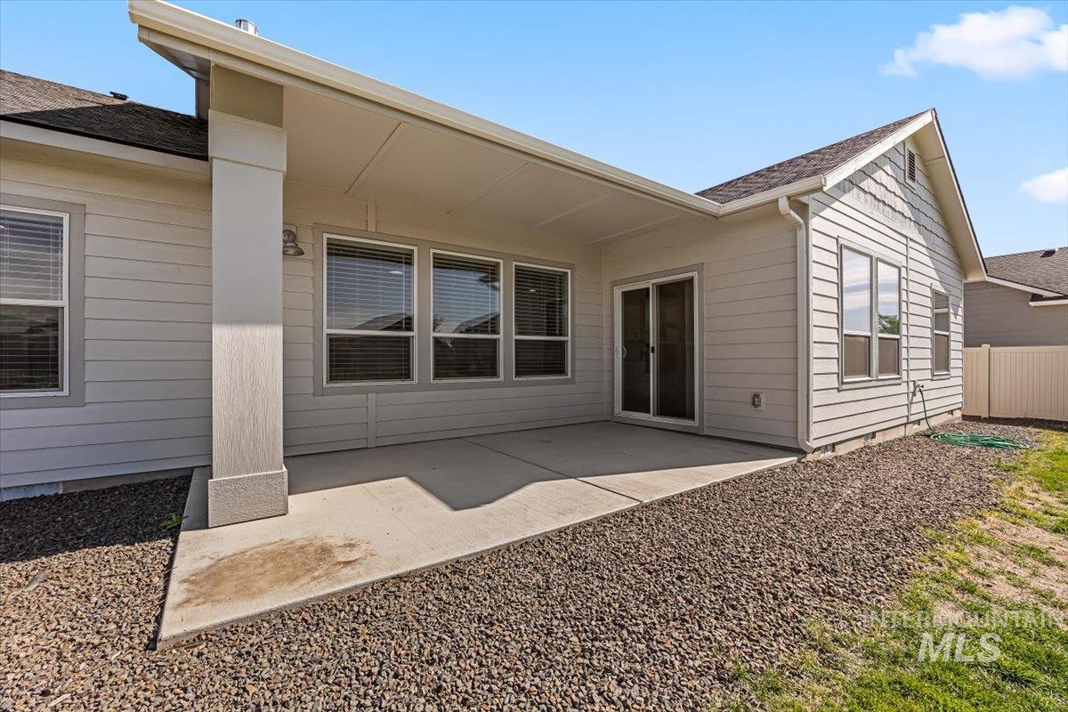 15365 Lutsen Avenue Caldwell, ID 83607 - Photo 35 of 42 Rear view of property with a patio and roof with shingles