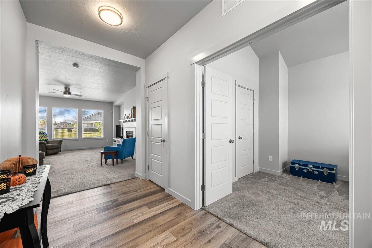 15365 Lutsen Avenue Caldwell, ID 83607 - Photo 10 of 42 Corridor featuring a textured ceiling, light colored carpet, and light wood finished floors