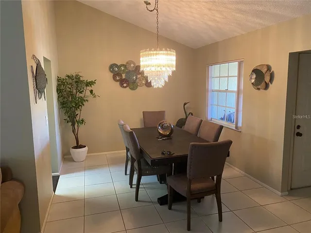a view of a dining room with furniture and chandelier