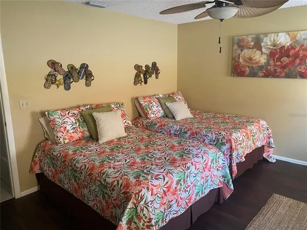 a bedroom with a bed and painting on the wall