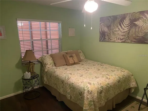 a bed sitting in a bedroom next to a window