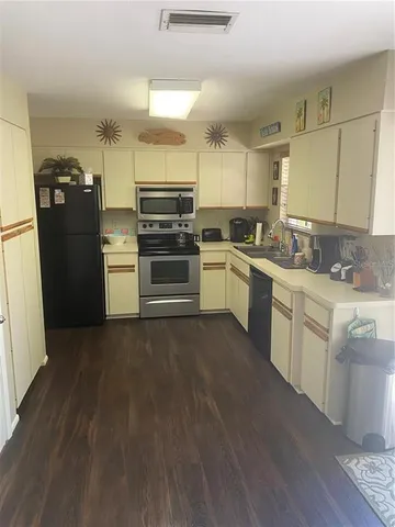 a kitchen with a sink cabinets and stainless steel appliances