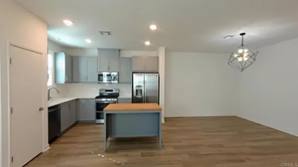 a large kitchen with stainless steel appliances kitchen island a large island in the center