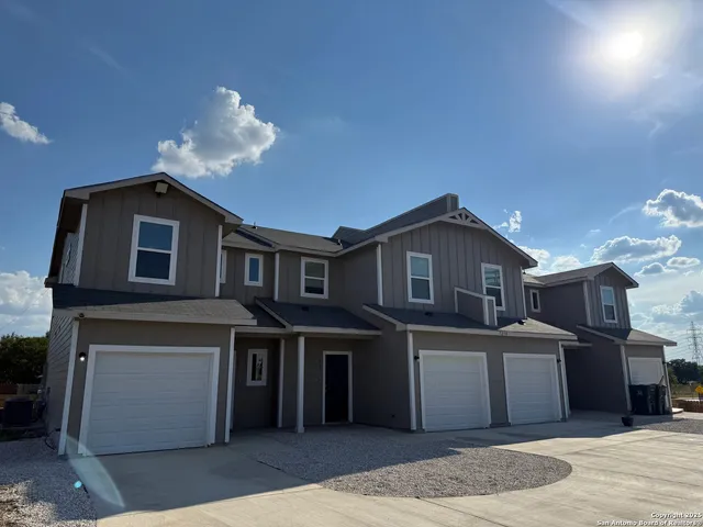 a kitchen that has a lot of cabinets and wooden floor