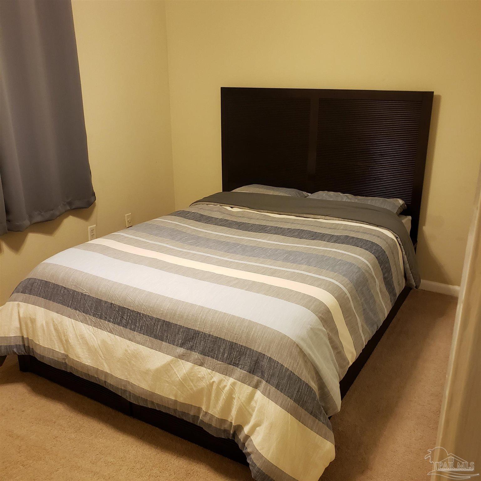 7270 Belgium Road Pensacola, FL 32526 - Photo 12 of 13 a bedroom with a bed and a night stand