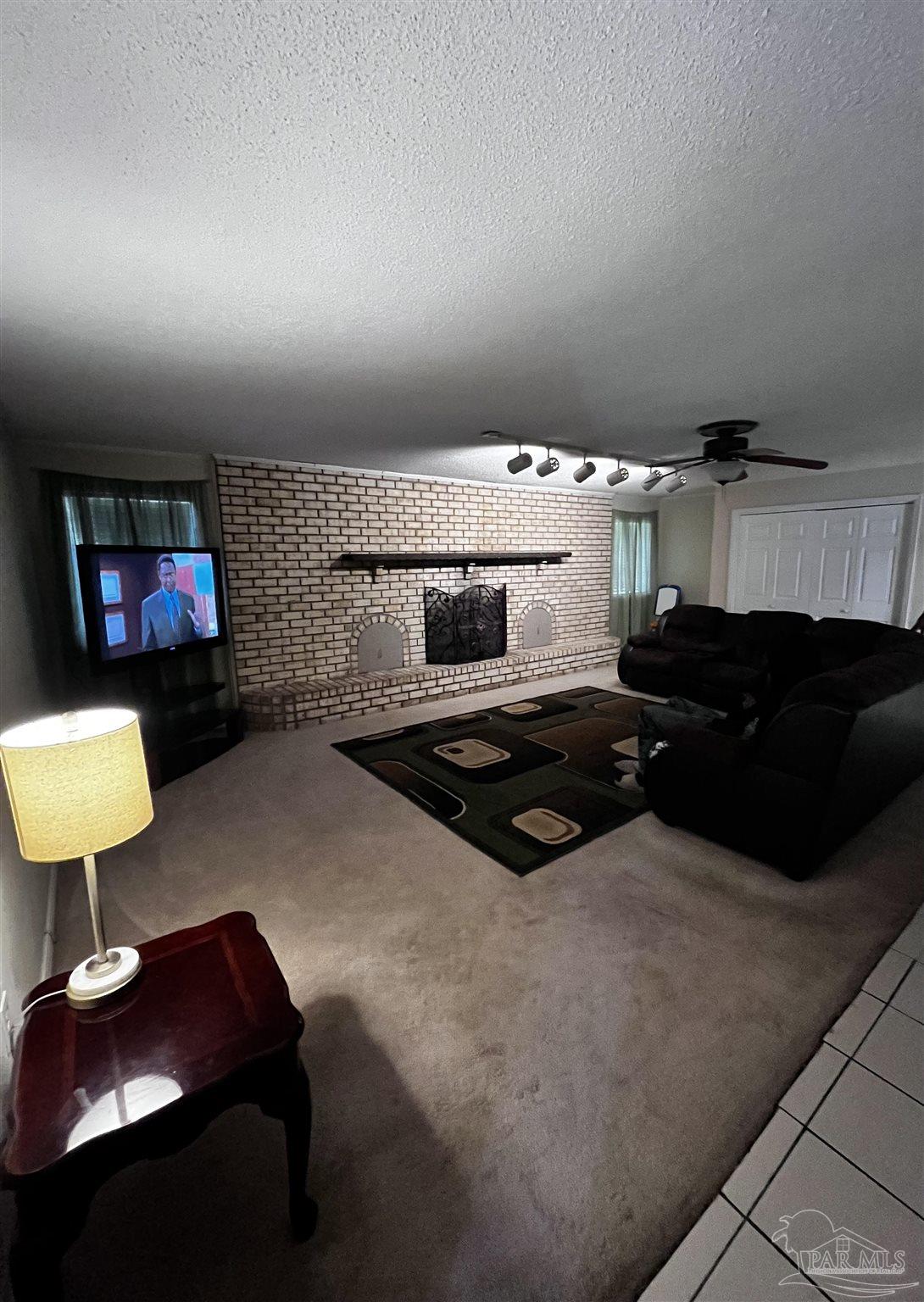 7270 Belgium Road Pensacola, FL 32526 - Photo 3 of 13 a living room with furniture and a flat screen tv