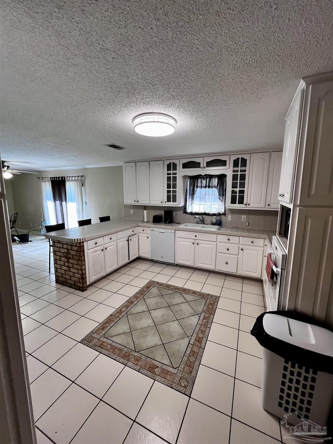 7270 Belgium Road Pensacola, FL 32526 - Photo 4 of 13 a kitchen with stainless steel appliances granite countertop a stove a sink a microwave a refrigerator and cabinets