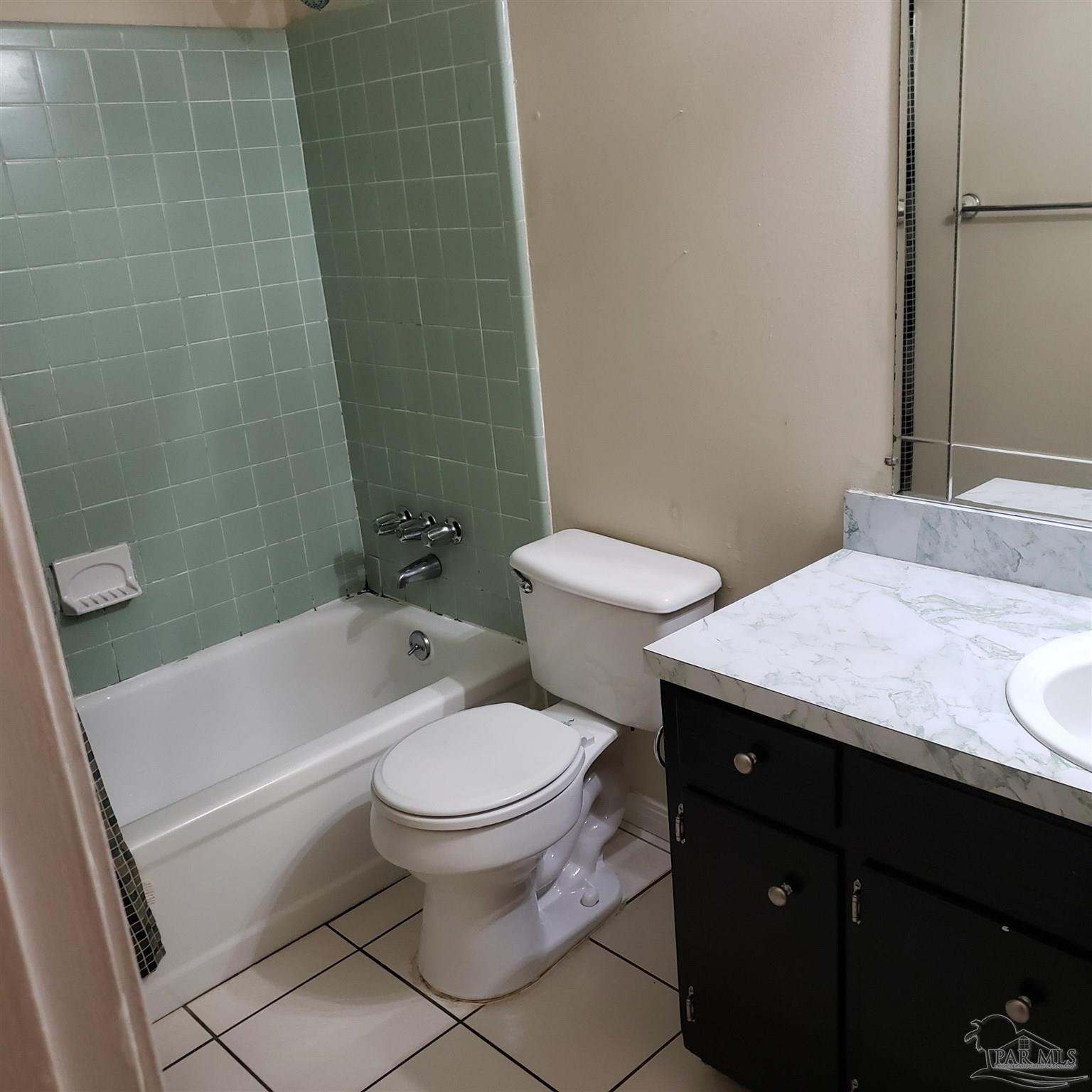 7270 Belgium Road Pensacola, FL 32526 - Photo 7 of 13 a bathroom with a granite countertop toilet a sink and bathtub