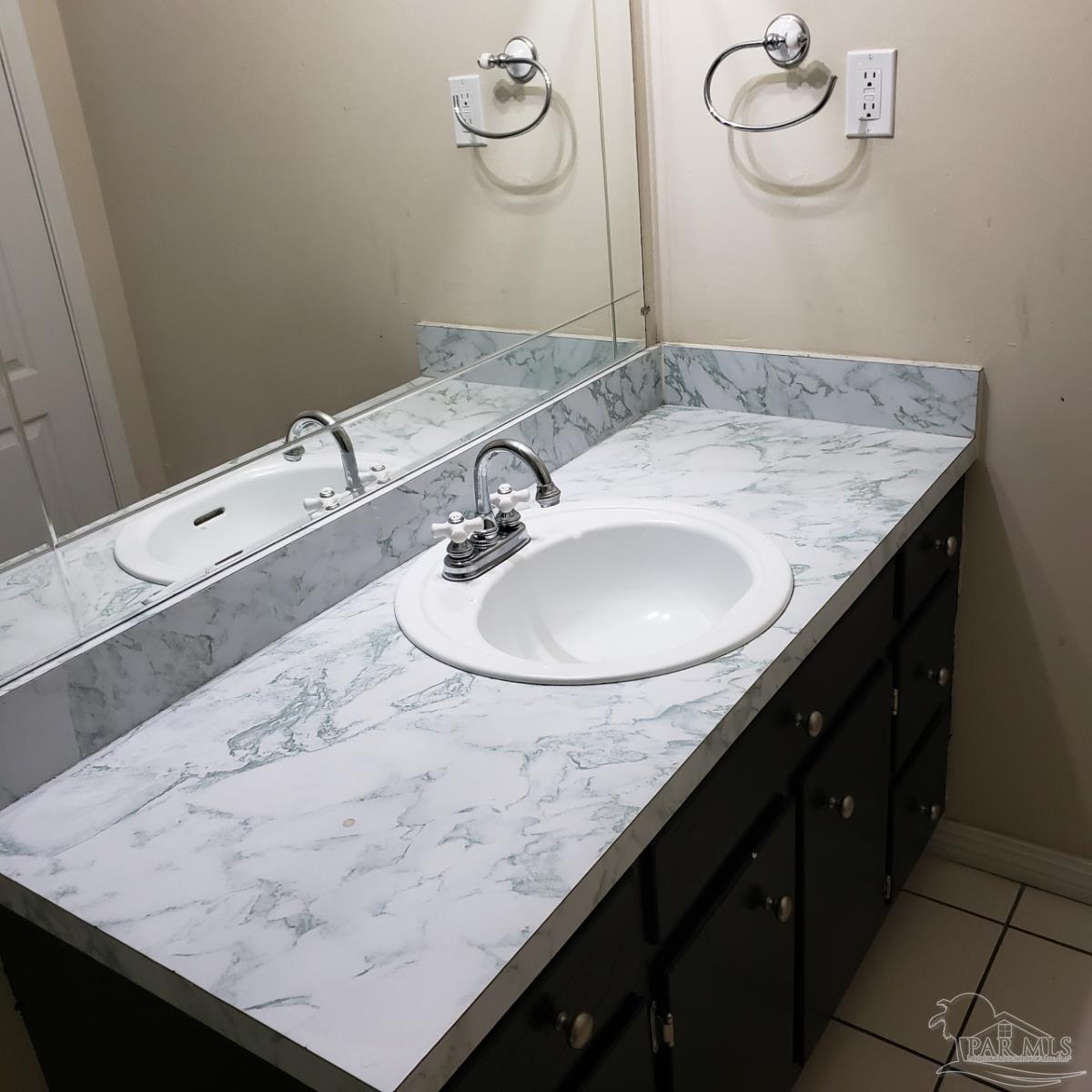 7270 Belgium Road Pensacola, FL 32526 - Photo 9 of 13 a bathroom with a granite countertop sink a mirror and vanity