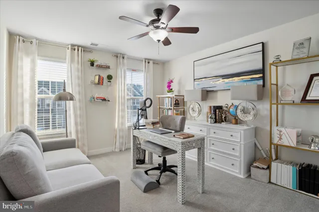 a view of a livingroom with workspace and a window