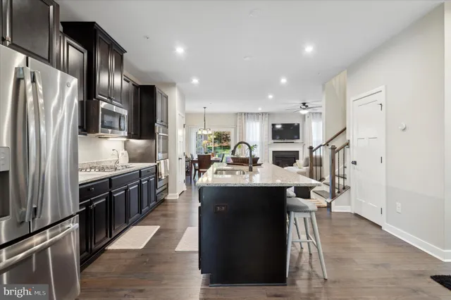 a large kitchen with stainless steel appliances lots of counter space and breakfast area