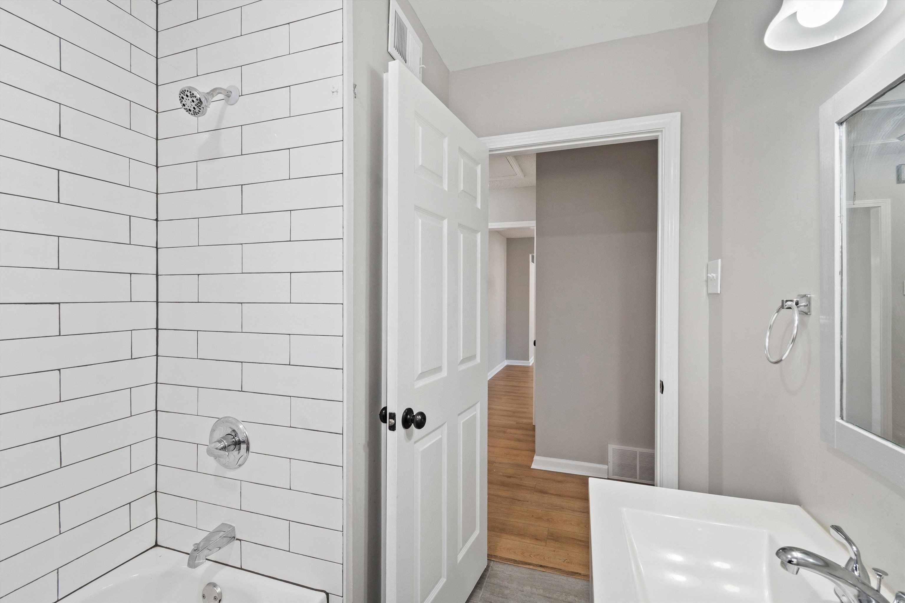 4487 East Dearing Road Memphis, TN 38117 - Photo 20 of 27 Bathroom with shower / bathtub combination and wood finished floors