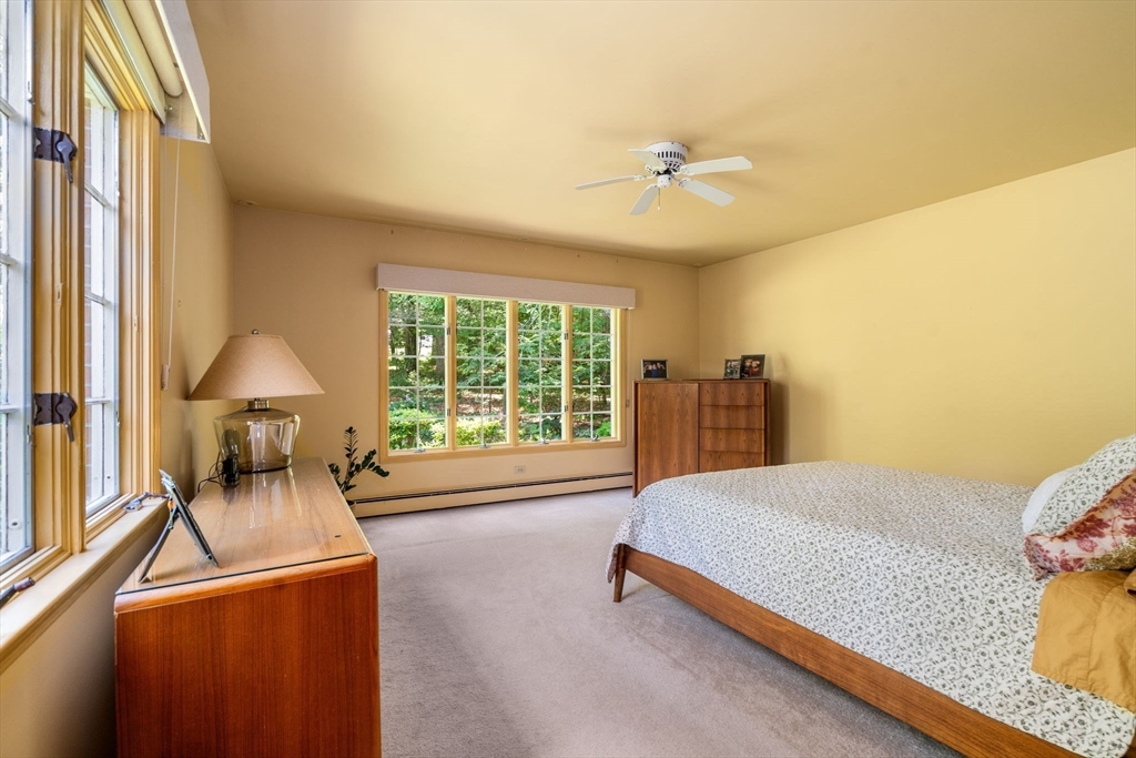 62 Mill Street Sherborn, MA 01770 - Photo 21 of 36 a bed room with a bed and a chandelier