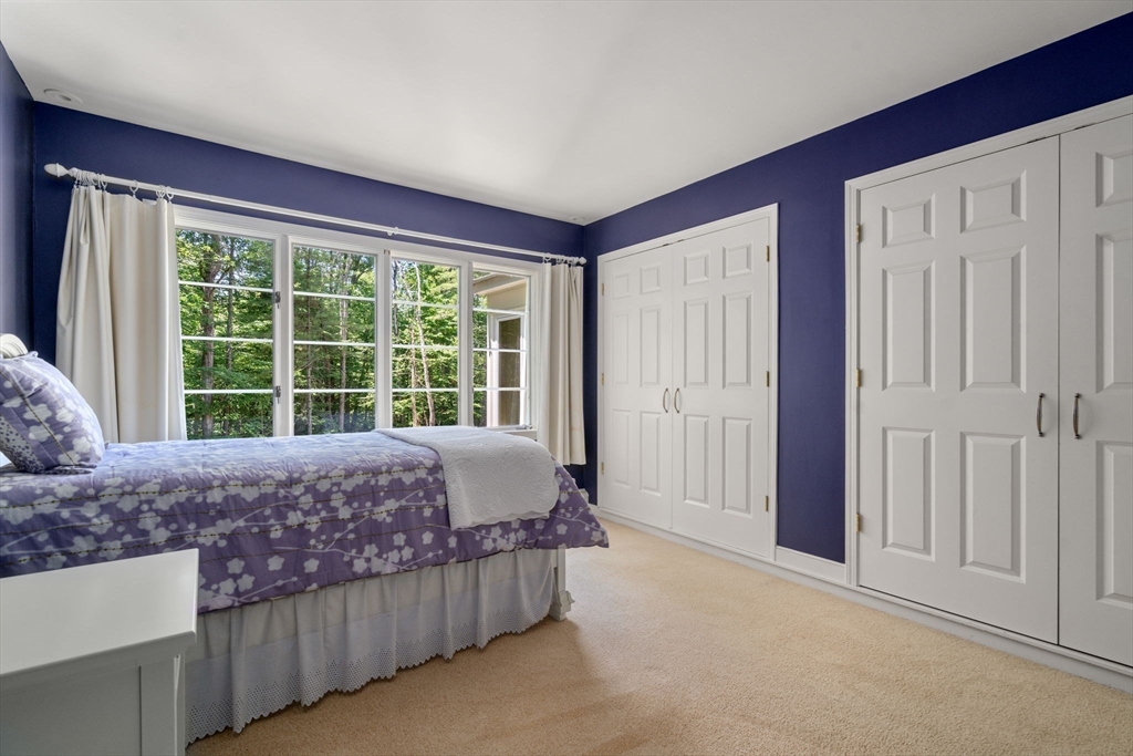 62 Mill Street Sherborn, MA 01770 - Photo 24 of 36 a bed sitting in a spacious bedroom next to a window