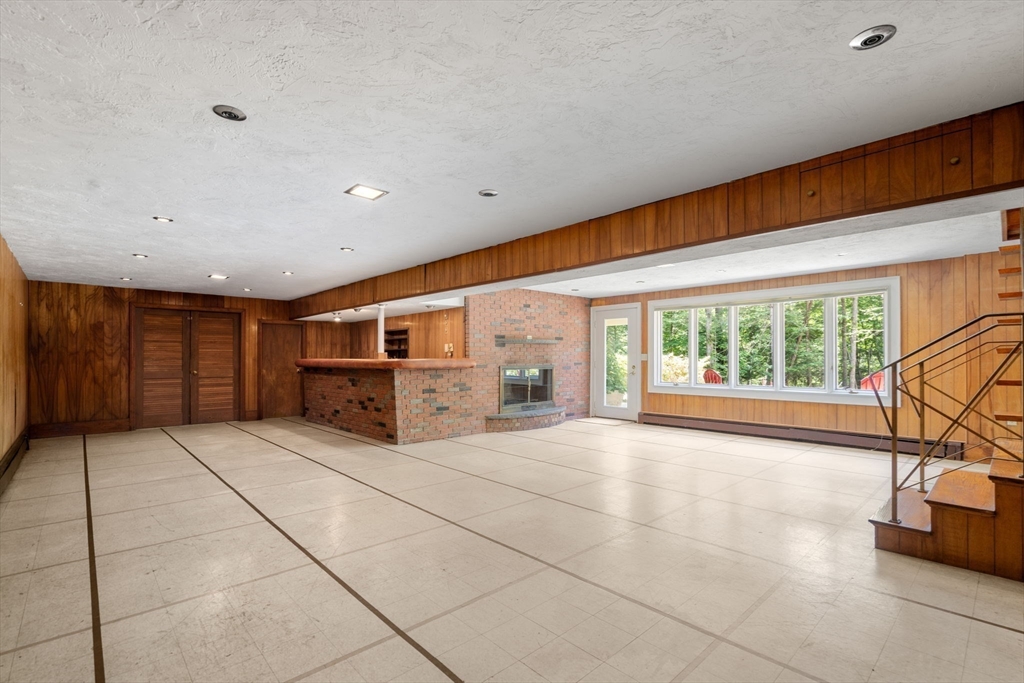 62 Mill Street Sherborn, MA 01770 - Photo 29 of 36 a spacious bedroom with a large window and a table chair
