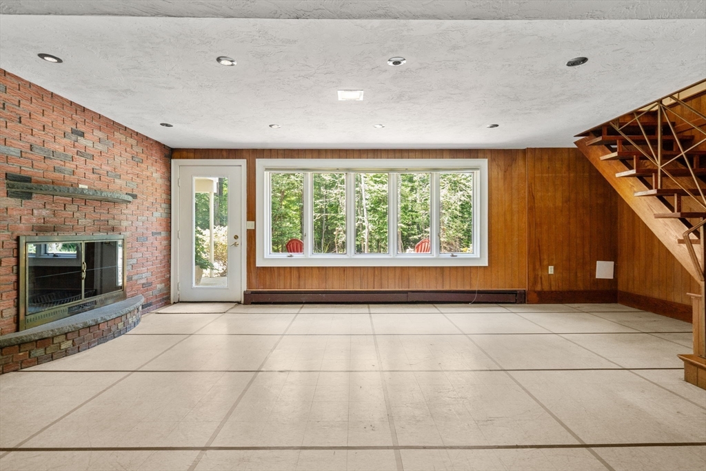 62 Mill Street Sherborn, MA 01770 - Photo 30 of 36 a view of an empty room with a fireplace and a window